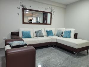 uma sala de estar com um sofá branco e um espelho em Apartamentos "APPART D'ELIETTE" em Trujillo