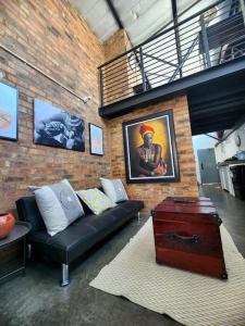 a living room with a couch and a brick wall at 353 Maboneng on Craft in Johannesburg
