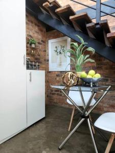 a kitchen with a table and a white refrigerator at 353 Maboneng on Craft in Johannesburg