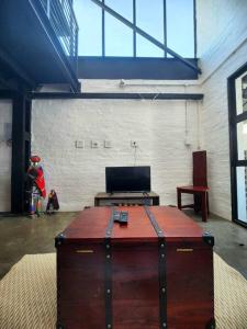 a room with a chest in the middle of a room at 353 Maboneng on Craft in Johannesburg