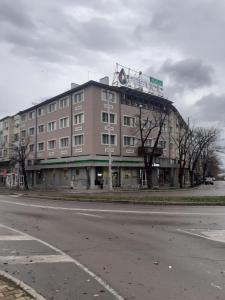 a large building on the side of a street at Роял Шумен in Shumen