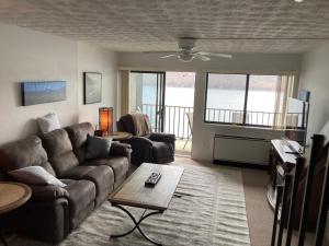 a living room with a couch and a table at Lakeside Condo with plenty of amenities close to Bristol Mountain - permit - 2024-0018 in Canandaigua