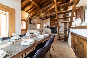 een eetkamer met een lange tafel en stoelen bij Chalet vue Mont-Blanc, +4 Chambres, cheminée in Megève