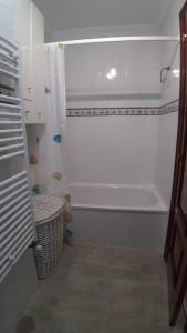 a white bathroom with a tub and a shower at Santander centro in Santander