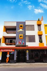 a building with a sign on the front of it at Hotel Portada Del Sol in Trujillo