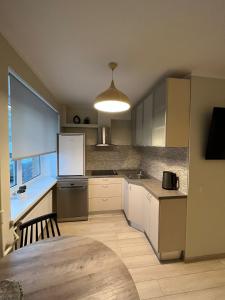 a kitchen with a white refrigerator and a table at Beautiful Apartment Great Location FREE PARKING in Rīga