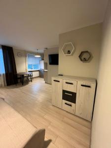 a living room with a kitchen and a dining room at Beautiful Apartment Great Location FREE PARKING in Rīga