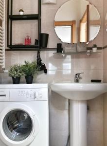 a bathroom with a washing machine and a sink at Loft ristrutturato vicino M4 Argonne - San Benigno in Milan