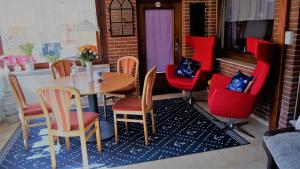une salle à manger avec une table et des chaises rouges dans l'établissement Hus Finkwarder, à Büsum