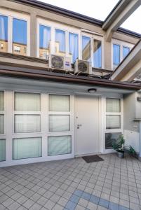 a garage with white doors and windows at Loft ristrutturato vicino M4 Argonne - San Benigno in Milan