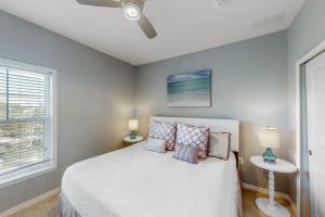 a bedroom with a bed with two lamps and a window at Azure Dream in Perdido Key +30 photos