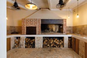 a living room with a brick fireplace in a room at Villa Vito in Hvar