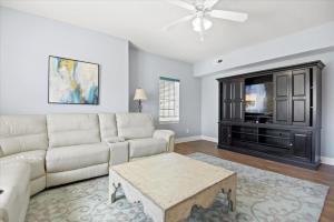 a living room with a couch and a tv at 3bd 2bth Huge Condo! Golf & Beach Winter Getaway! in Myrtle Beach