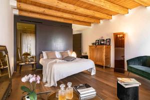 a bedroom with a bed and a couch and a table at CasaVostra - Ambience Suites in Ostra Vetere