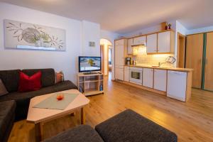 a living room with a couch and a table at Apartment Bacher in Wald im Pinzgau