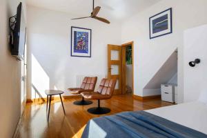 a bedroom with two chairs and a bed and a staircase at Villa Vito in Hvar