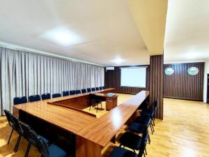 a large conference room with a large wooden table and chairs at Asem Hotel in Nukus