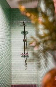 a person standing in a bathroom with a towel rack on a wall at Villa la Vida in Tilburg