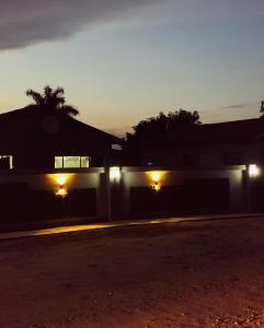 a house with lights on the side of it at night at KO'THABENG GUESTHOUSE in Lebowakgomo