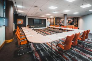 a large conference room with a long table and chairs at Clayton Hotel Birmingham in Birmingham