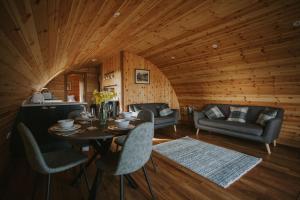 a room with a table and chairs in a cabin at Snowdrop in Rhayader