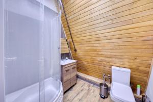 a bathroom with a shower and a toilet and a sink at Alpine Castle Hotel in Dilijan +74 photos