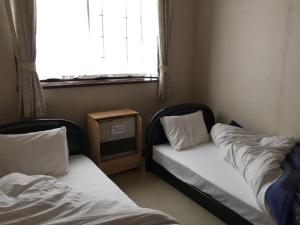 En eller flere senger på et rom på Resort Inn Daiju