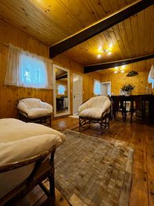 a bedroom with two beds and a dining room with a table at Apartamento Foss in Gramado