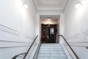 un pasillo con escaleras y una puerta con un árbol de Navidad en Vaticano Luxury Guest House, en Roma