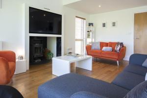 a living room with two couches and a tv at Clearwater 74, Goldcrest P in Somerford Keynes