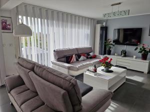a living room with a couch and a table at Chambres d'hôtes Chez Pat et Nanou in Six-Fours-les-Plages