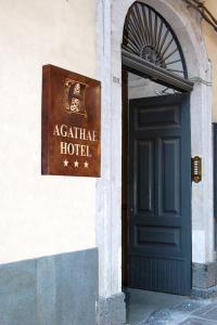 a door leading to a building with a sign on it at Hotel Agathae in Catania
