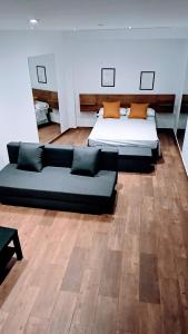 a large room with two beds and a couch at apartamento Ciempozuelos II in Ciempozuelos