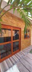 a building with glass doors and a palm tree at Hotelito Villas Holbox in Holbox Island