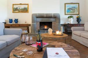 a living room with a couch and a fireplace at Nèroli Bio Relais in Catania
