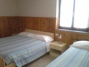 Postel nebo postele na pokoji v ubytování Hotel Ticino Ristorante Chierico