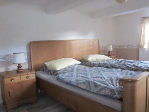 een slaapkamer met een bed met 2 nachtkastjes en 2 lampen bij Ferienhaus Zum alten Standesamt in Weenzen