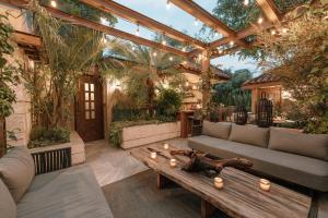 an outdoor living room with a wooden pergola at CASA LUCIANA Condesa in Mexico City