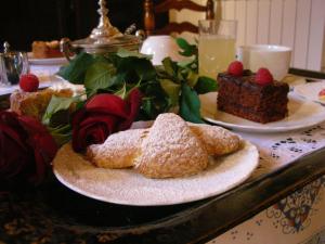 a table with some pastries and a piece of cake at Palazzo Torriani in Marradi