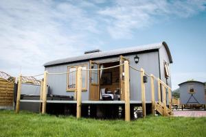 a tiny house on a trailer in a field at Lily in Rhayader