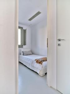 a bedroom with a bed in a white room at Empire Luxury Villas in Santa Maria