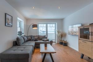 a living room with a couch and a table at Hooge in Hattstedt