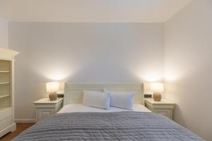 a bedroom with a large bed with two night stands at Hooge in Hattstedt