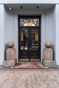 a door to a building with a sign on it at Smart park view studio in heart of Riga 5 min to Old Town in Riga