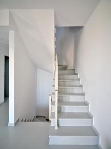 a staircase in a building with white walls at Empire Luxury Villas in Santa Maria