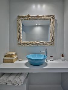 a bathroom with a large blue bowl on a sink at Empire Luxury Villas in Santa Maria