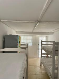 a room with two bunk beds in a room at Hué Hostel in Punta Del Diablo