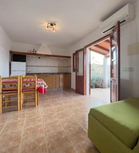 a living room with a table and a kitchen at Can Pep Yern 2 in Playa Migjorn