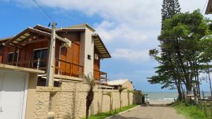 una casa en la playa con una valla en MarLuar Casa, en Penha
