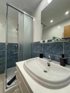 a bathroom with a sink and a glass shower at Aquamarina Beach in Alcudia